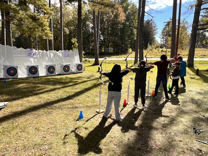 Kids shooting arrows at targets